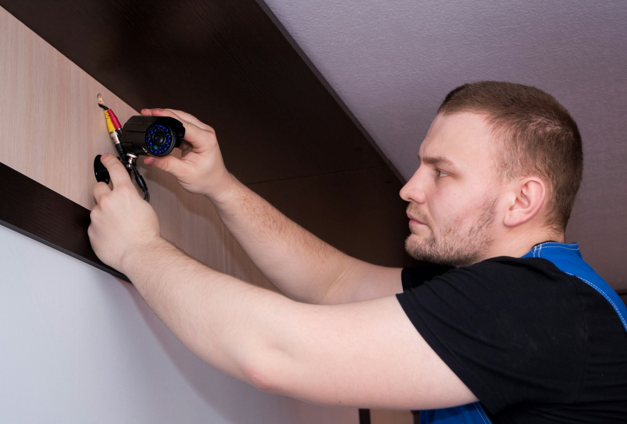 Alarm Service Fire technician servicing a security camera